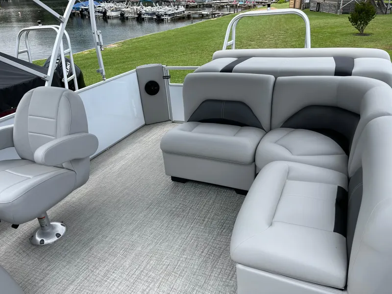 Slide: The Image of 2024 Landau Island Breeze 232 Cruise pontoon boat with gray seating and spacious deck. - 15