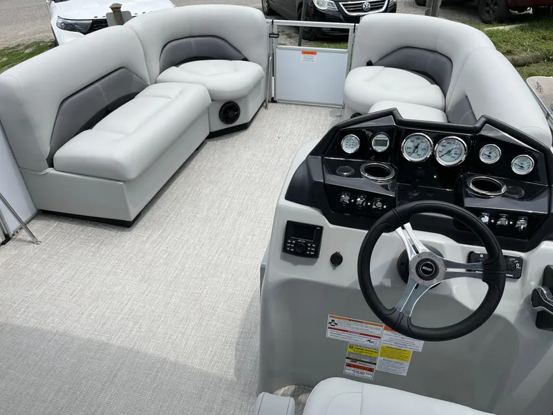 Slide: The Image of 2024 Landau Island Breeze 232 Cruise pontoon boat interior with plush seating and modern dashboard. - 7