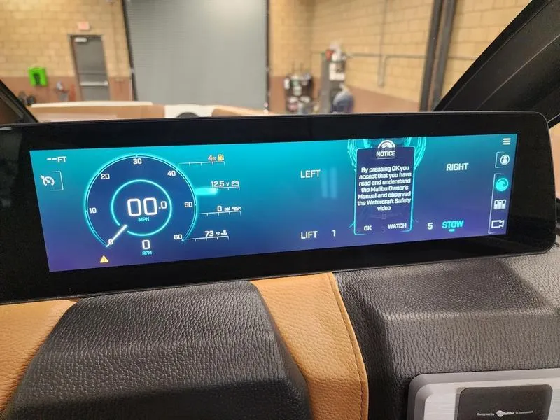 Slide: The Image of Dashboard of 2025 Malibu 24 MXZ boat displaying digital speedometer and controls. - 14