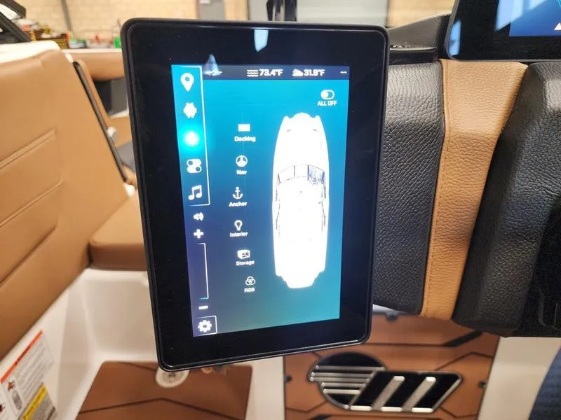 Slide: The Image of 2025 Malibu 24 MXZ boat touchscreen display with control options and navigation interface. - 15