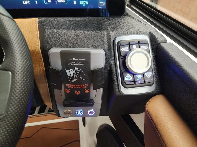 Slide: The Image of 2025 Malibu 24 MXZ dashboard with phone holder and control panel. - 16