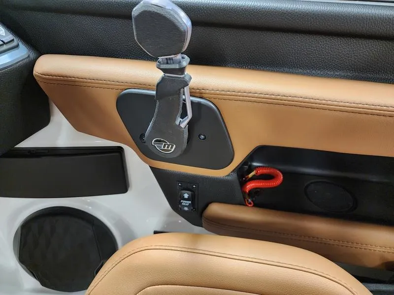 Slide: The Image of 2025 Malibu 24 MXZ interior with tan leather and key holder detail. - 17