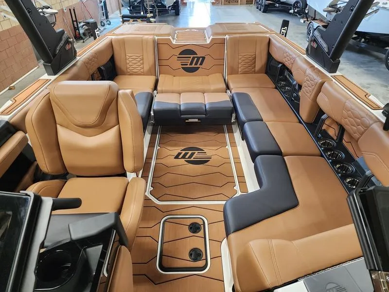 Slide: The Image of Luxurious interior of 2025 Malibu 24 MXZ boat with tan leather seating. - 18