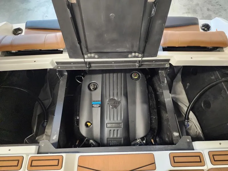 Slide: The Image of 2025 Malibu 24 MXZ engine compartment with open hatch, showcasing the engine details. - 24
