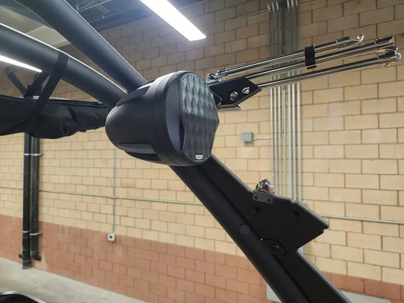 Slide: The Image of 2025 Malibu 24 MXZ boat speaker and tower detail in a garage setting. - 27