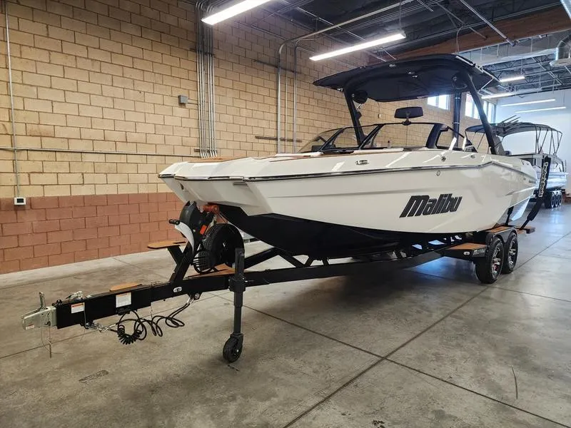 Slide: The Image of 2025 Malibu 24 MXZ boat on trailer in indoor storage facility. - 8