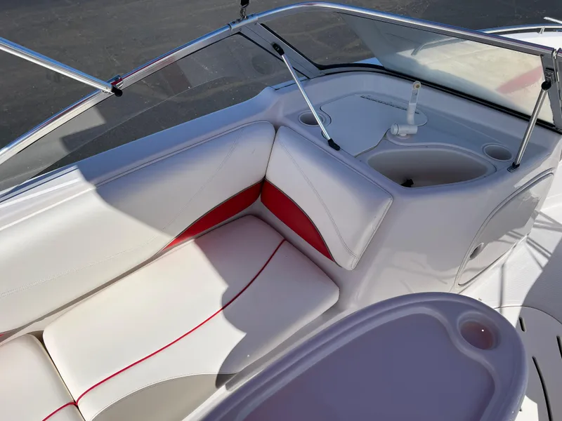 Slide: The Image of 2006 Tahoe 204 WT boat interior with white and red seating, cup holders, and windshield. - 15
