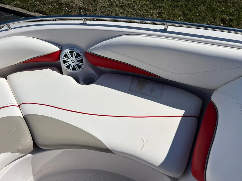Slide: The Image of 2006 Tahoe 204 WT boat interior with white and red seating and speaker. - 20