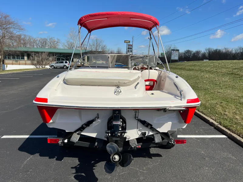 Slide: The Image of 2006 Tahoe 204 WT boat with red canopy in parking lot, rear view. - 6