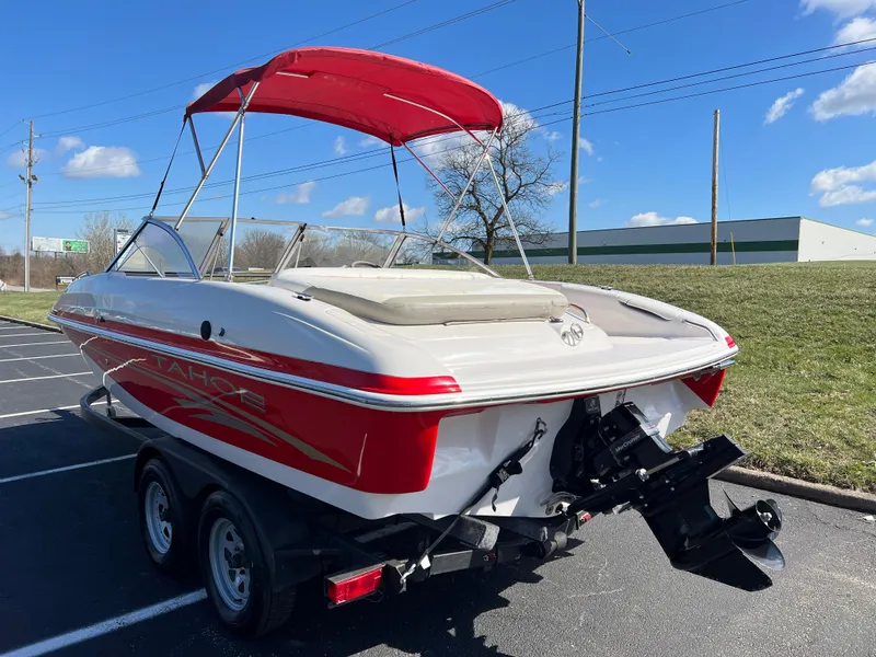 Slide: The Image of 2006 Tahoe 204 WT boat with red accents and canopy on a trailer. - 7