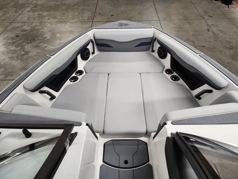 Slide: The Image of 2025 Axis T235 boat interior with gray seating and cup holders. - 10