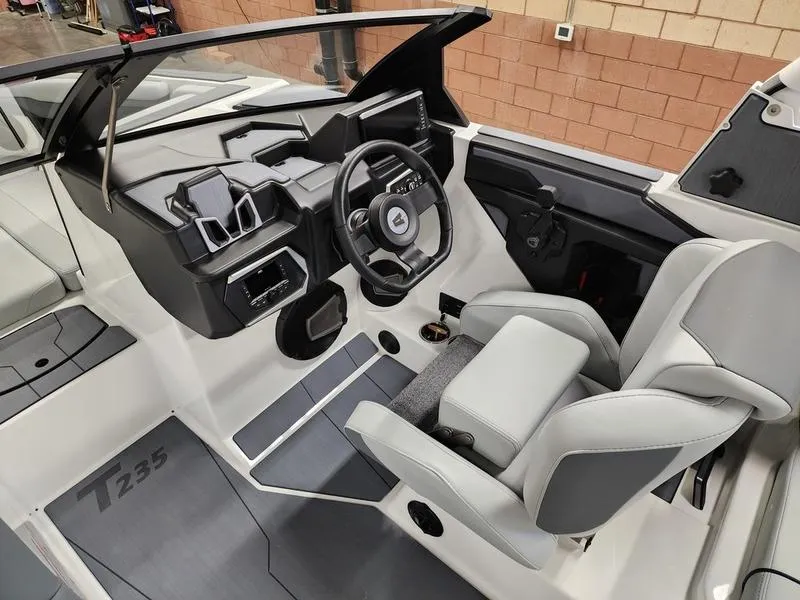 Slide: The Image of 2025 Axis T235 boat interior with modern dashboard and steering wheel design. - 12