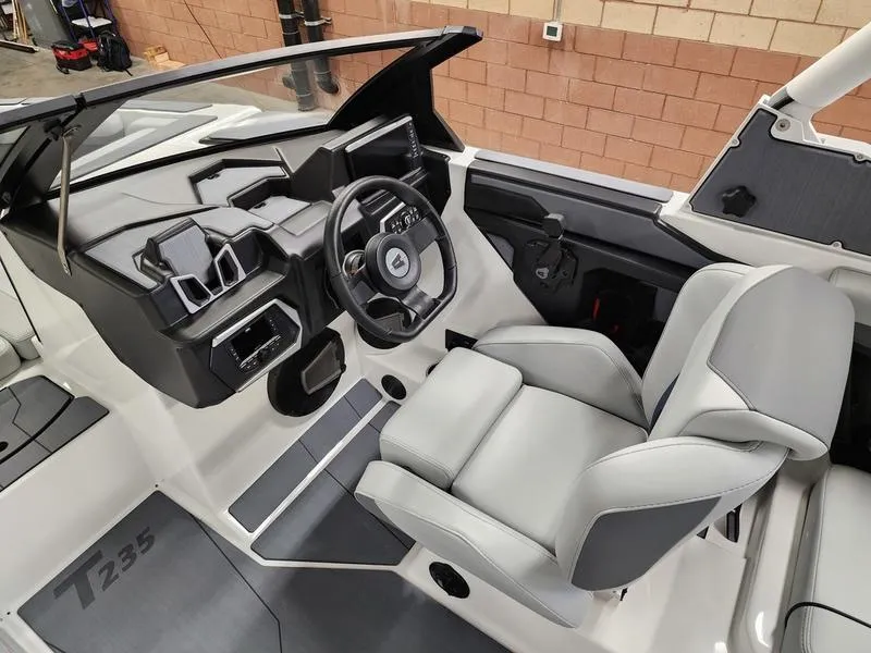 Slide: The Image of 2025 Axis T235 boat interior with modern dashboard and comfortable seating. - 13