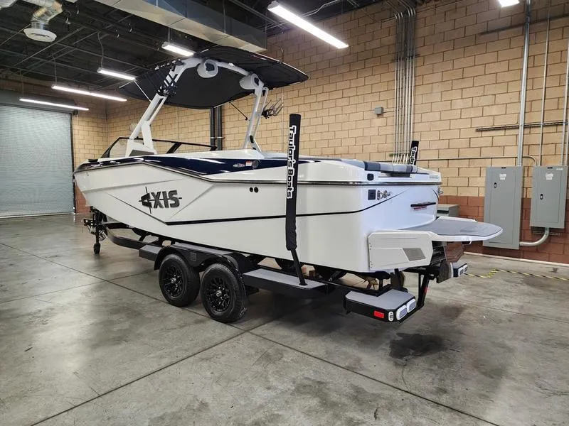 Slide: The Image of 2025 Axis T235 boat on trailer in a warehouse setting. - 3