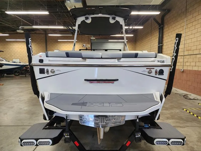 Slide: The Image of 2025 Axis T235 boat in a garage, showcasing rear design and features. - 5