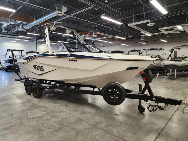 Slide: The Image of 2025 Axis T235 boat on trailer in showroom, featuring sleek design and modern amenities. - 6
