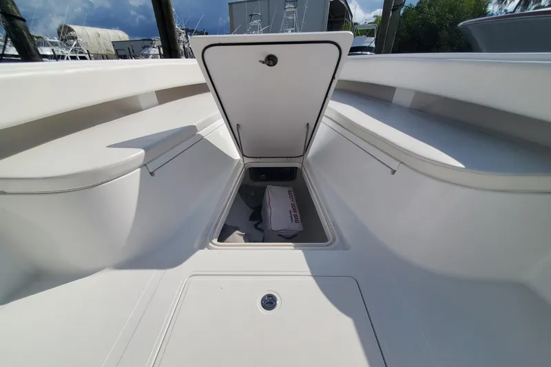 Slide: The Image of 2014 Bahama 41 FS boat interior storage compartment with open hatch, showcasing spacious design. - 13