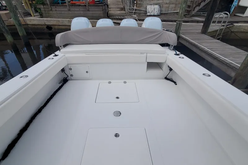 Slide: The Image of 2014 Bahama 41 FS boat deck with four engines at dock. - 16