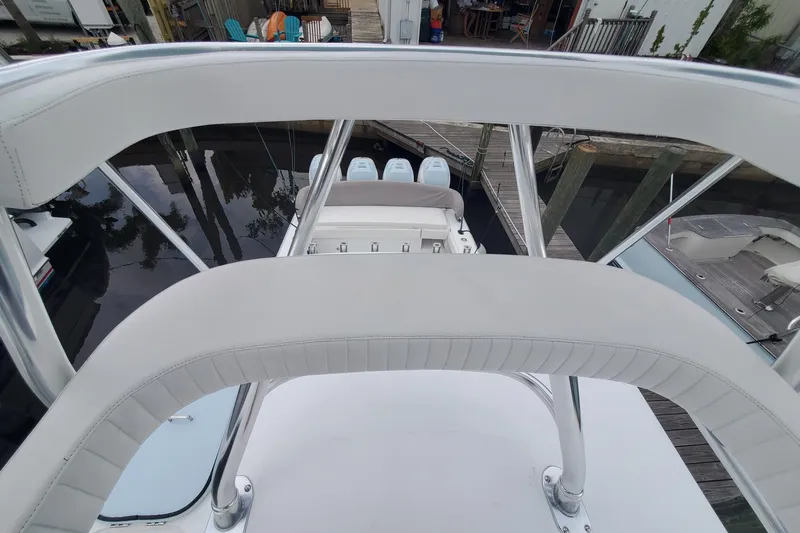 Slide: The Image of 2014 Bahama 41 FS boat with white seating and triple outboard engines. - 20