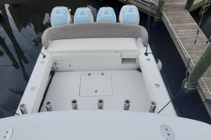 Slide: The Image of 2014 Bahama 41 FS boat with four engines docked at a marina. - 25