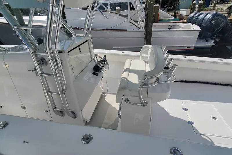 Slide: The Image of 2014 Bahama 41 FS boat interior with helm station and seating, docked at marina. - 4