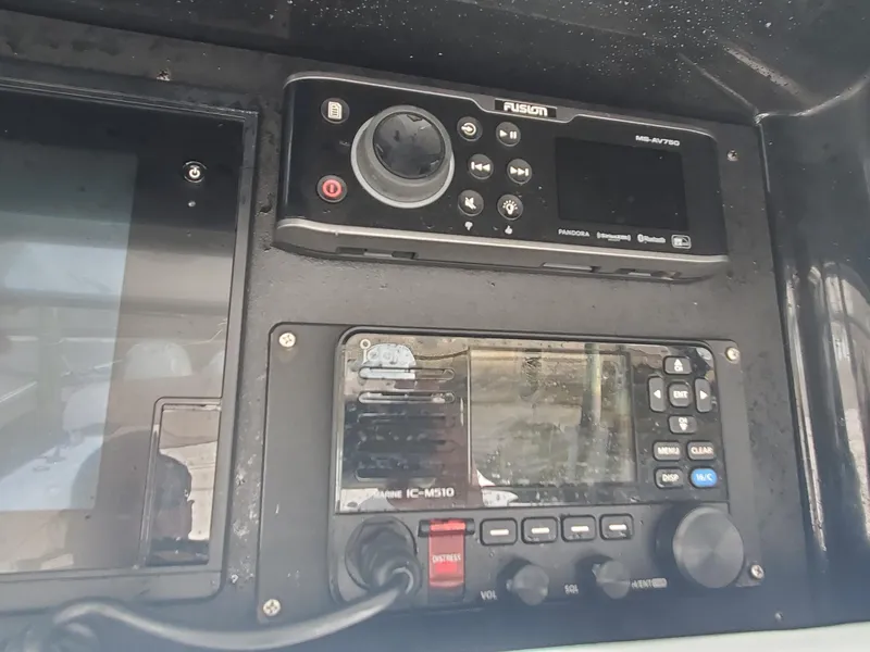 Slide: The Image of Control panel of a 2014 Bahama 41 FS boat with Fusion and Icom devices. - 8