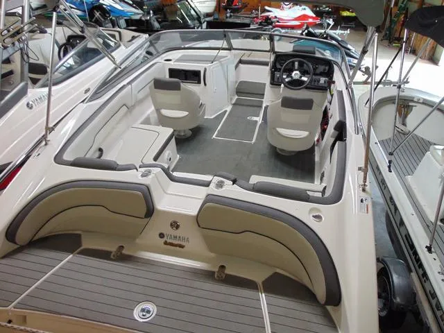 Slide: The Image of 2021 Yamaha Boats SX190 interior with seating and steering wheel, displayed in showroom. - 3