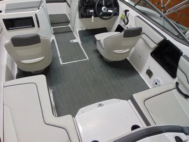 Slide: The Image of 2021 Yamaha Boats SX190 interior with gray flooring and modern seating. - 4