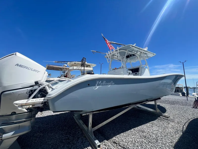 Slide: The Image of 2021 Yellowfin 36 Offshore boat with Mercury engines, displayed on gravel under clear blue sky. - 12