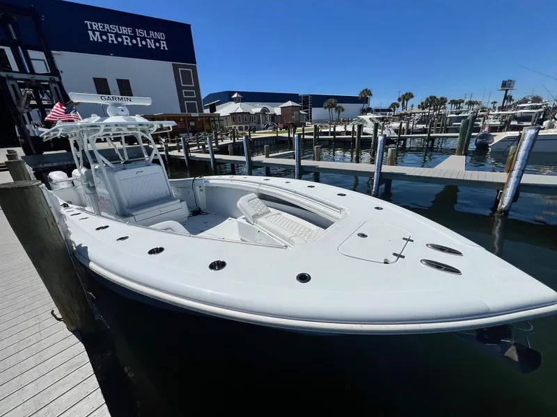 Slide: The Image of 2021 Yellowfin 36 Offshore boat docked at Treasure Island Marina under clear blue skies. - 13
