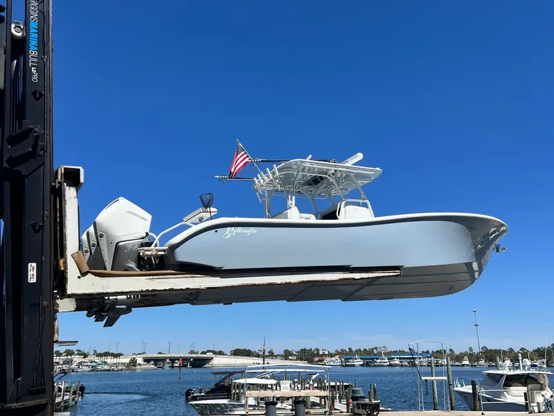 Slide: The Image of 2021 Yellowfin 36 Offshore boat lifted at marina, clear blue sky background. - 14