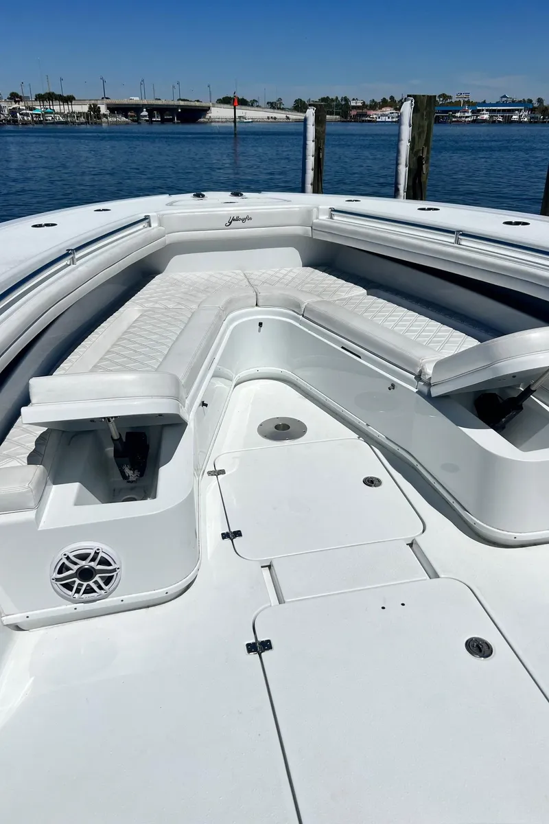 Slide: The Image of 2021 Yellowfin 36 Offshore boat with spacious seating, docked by the water. - 17