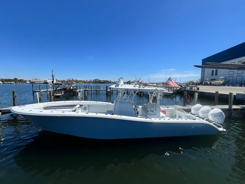 Slide: The Image of 2021 Yellowfin 36 Offshore boat docked at marina under clear blue sky. - 2