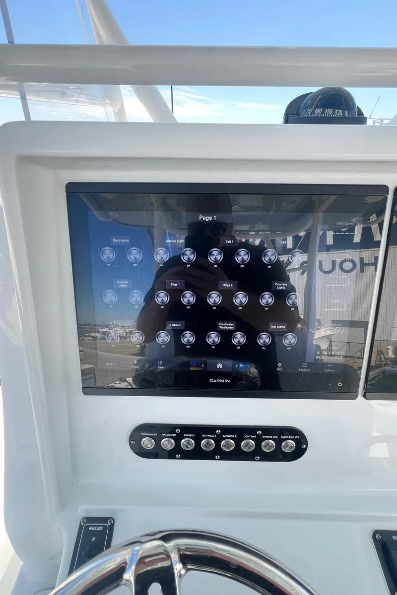 Slide: The Image of 2021 Yellowfin 36 Offshore dashboard with modern controls and steering wheel. - 20