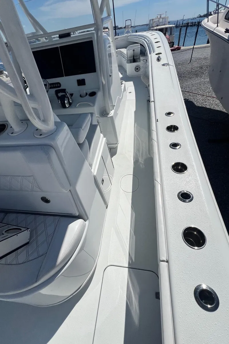 Slide: The Image of 2021 Yellowfin 36 Offshore boat interior with sleek white design and modern controls. - 21
