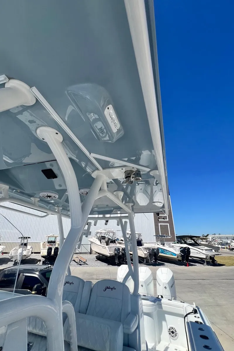 Slide: The Image of 2021 Yellowfin 36 Offshore boat with sleek design and modern features, docked under clear blue sky. - 24