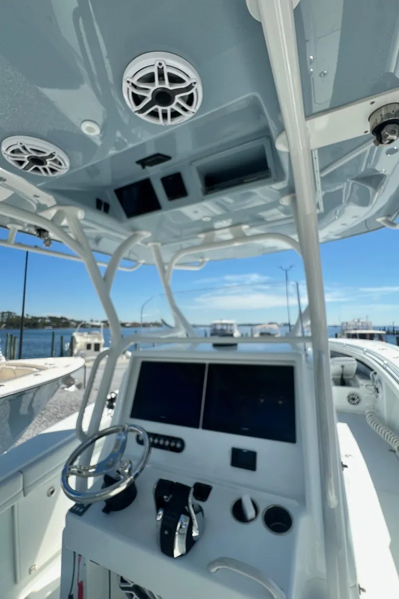 Slide: The Image of 2021 Yellowfin 36 Offshore boat cockpit with modern controls and ocean view. - 26