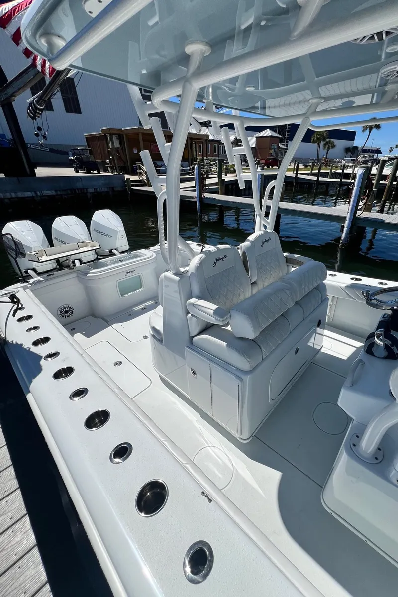 Slide: The Image of 2021 Yellowfin 36 Offshore boat with spacious seating and modern design at a dock. - 28
