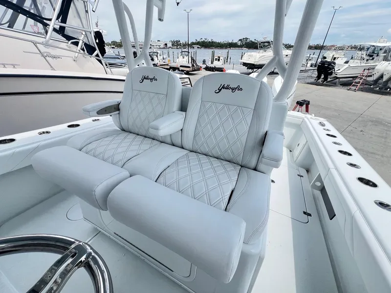 Slide: The Image of 2021 Yellowfin 36 Offshore boat with luxurious white seating at a marina. - 29