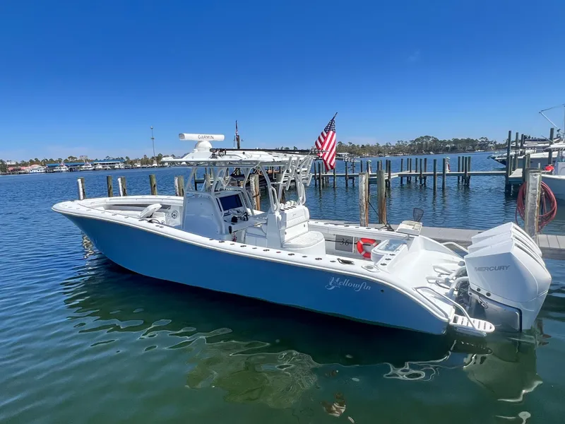Slide: The Image of 2021 Yellowfin 36 Offshore boat docked, featuring sleek design and American flag. - 3