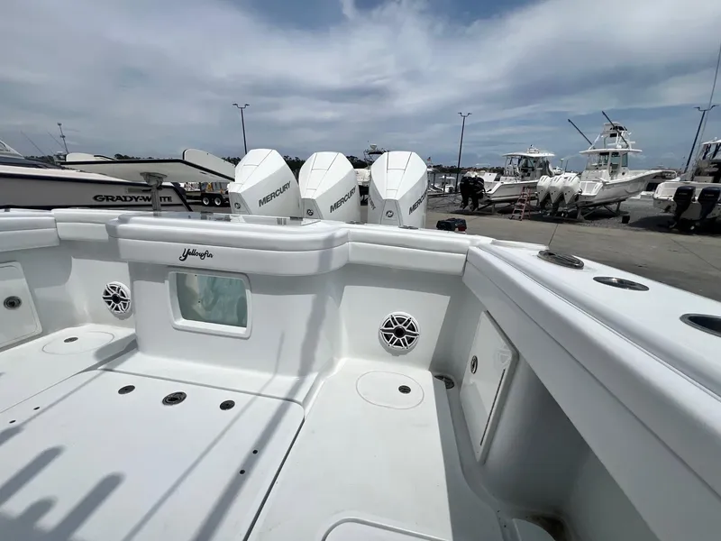 Slide: The Image of 2021 Yellowfin 36 Offshore boat with triple Mercury engines at a marina. - 30