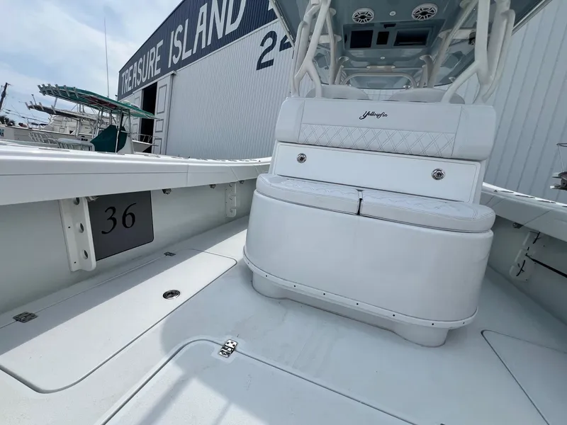 Slide: The Image of 2021 Yellowfin 36 Offshore boat interior with seating, docked near a marine facility. - 31