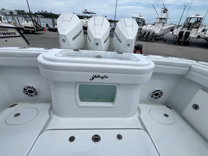 Slide: The Image of 2021 Yellowfin 36 Offshore boat with triple Mercury engines at a marina. - 37