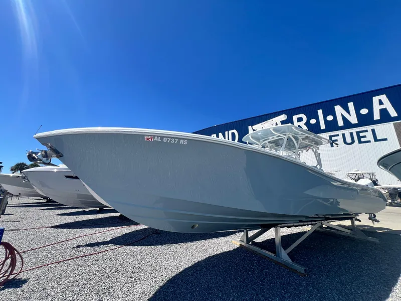 Slide: The Image of 2021 Yellowfin 36 Offshore boat displayed at a marina under clear blue skies. - 4