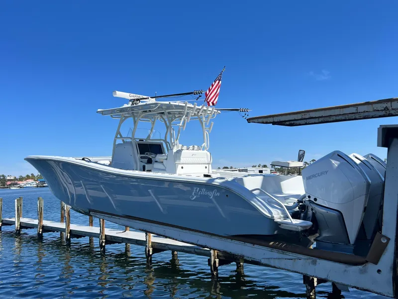 Slide: The Image of 2021 Yellowfin 36 Offshore boat docked, featuring sleek design and powerful Mercury engines. - 6