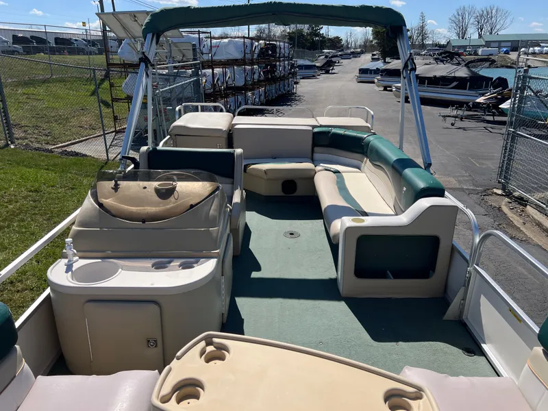 Slide: The Image of 1998 Fisher Freedom 200 DLX pontoon boat with spacious seating and canopy, docked outdoors. - 12