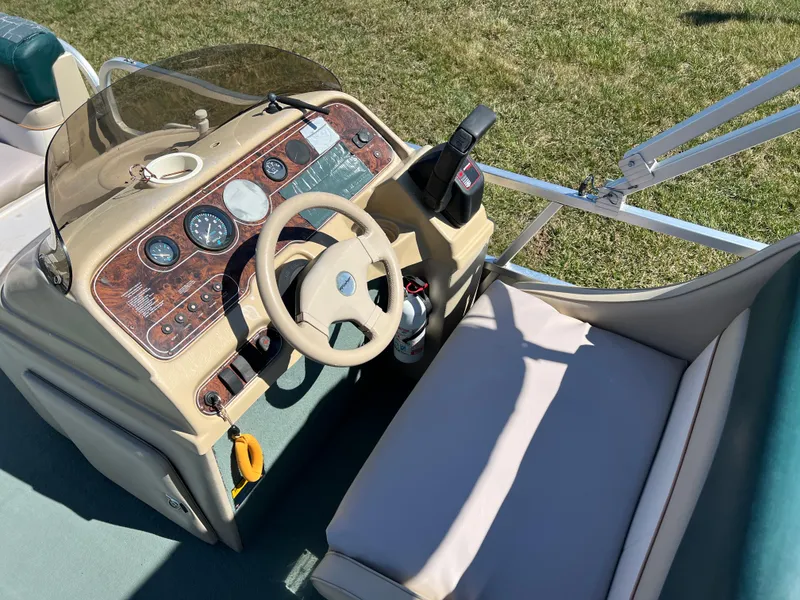 Slide: The Image of 1998 Fisher Freedom 200 DLX boat dashboard with steering wheel and controls. - 19