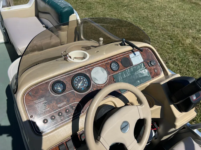 Slide: The Image of 1998 Fisher Freedom 200 DLX boat dashboard with steering wheel and control panel. - 20