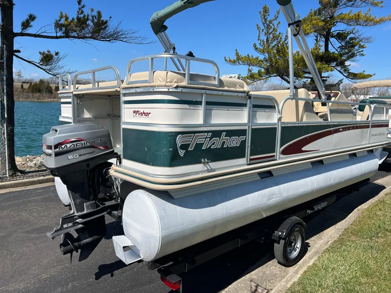 Slide: The Image of 1998 Fisher Freedom 200 DLX pontoon boat on trailer by a lake. - 5