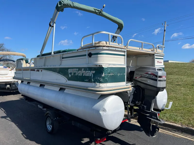 Slide: The Image of 1998 Fisher Freedom 200 DLX pontoon boat with outboard motor on trailer. - 7